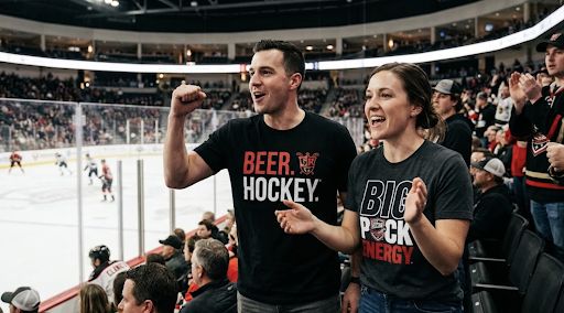 Hockey fans wearing Beer. Hockey.® and Big Puck Energy® T-shirts